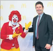  ??  ?? Steve Easterbroo­k, the former McDonald’s CEO, poses with Ronald McDonald at an event at Frankfurt Airport in March