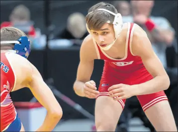  ?? MICHAEL GARD/POST-TRIBUNE ?? Crown Point’s Logan Frazier, right, wrestles against Jay County’s Ethan Reiley in the 113pound weight class during the opening round of the state wrestling meet in Indianapol­is on Feb. 21, 2020.