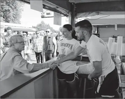  ?? [KYLE ROBERTSON/DISPATCH] ?? Gov. Mike Dewine shakes hands with Aaron Tracey while opening the Ohio State Fair on Wednesday. On Thursday, Dewine spent the night at the fair in a trailer with family.