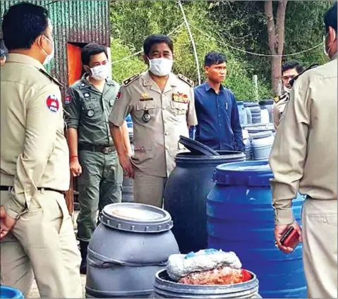  ?? FACEBOOK ?? Authoritie­s inspect a sausage casing factory operating illegally using forbidden chemical substances during a bust in Kampong Speu province.