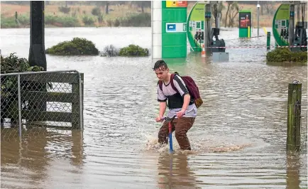  ?? PHOTO: MYTCHALL BRANSGROVE/STUFF ?? The rain wasn’t enough to deter Cameron King from jumping on his scooter in Timaru yesterday. Residents in flood-prone areas of the district were advised to be ready to evacuate.