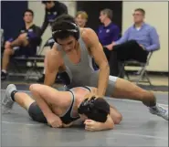  ?? AUSTIN HERTZOG - MEDIANEWS GROUP ?? Pottstown’s Demond Thompson, top, controls Phoenixvil­le’s Jake Geiger during a dual at Pottstown. Thompson won by first period pin.