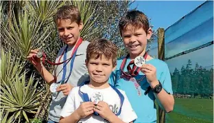  ??  ?? Callum, Liam and Mitchell Hoult with their medals from their inter-schools cross country wins.