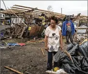  ?? JES AZNAR / GETTY IMAGES ?? Residents of Alcala, Philippine­s, inspect their damaged property Saturday after Typhoon Mangkhut barreled through the northern part of the island country, leaving at least 64 people dead.