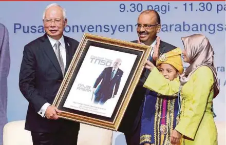 ?? PIC BY AHMAD IRHAM MOHD NOOR ?? Prime Minister Datuk Seri Najib Razak receiving a souvenir during the Civil Service Premier Assembly in Putrajaya yesterday. With him is Chief Secretary to the Government Tan Sri Dr Ali Hamsa (third from right).