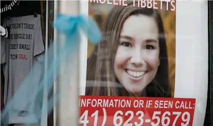  ?? Associated Press ?? ■ A ribbon for University of Iowa student Mollie Tibbetts hangs on a light post Tuesday in Brooklyn, Iowa. Tibbetts was reported missing last month from her hometown in the eastern Iowa city of Brooklyn. An illegal immigrant was charged in her slaying Tuesday after reportedly confessing.