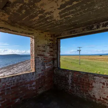  ??  ?? The WWII lookout over the sound at Gigha frames the landscape so that the scene looks like two flat-screen television­s. The windows filled the space with enough light that I could pull back the shadows with a single exposure. I debated whether to remove the telegraph pole in post-production but elected to keep it in: it draws the eye and hints at the habitation nearby.