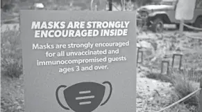  ?? DAVID ZALUBOWSKI/AP FILE ?? A sign encourages mask wearing at the Denver Zoo. Public hospital Denver Health is sending people elsewhere due to a lack of beds.