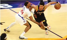  ?? Photograph: Mark J Rebilas/USA Today Sports ?? Suns guard Devin Booker (1) moves the ball against Clippers guard Norman Powell (24) during the second half of Tuesday’s game.