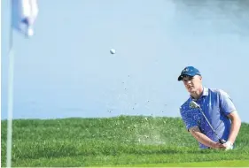  ?? AP ?? Jordan Spieth blasts out of the bunker on the 16th.