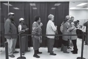  ?? STAFF PHOTO BY DOUG STRICKLAND ?? Voters wait in line to cast their ballots during early voting Saturday at the Hamilton County Election Commission.