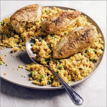  ?? CARL TREMBLAY — AMERICA’S TEST KITCHEN VIA AP ?? Spanish-style Chicken and Couscous.
160 F, 1 to 2 hours. (If using Instant Pot, select high slow cook function.) Turn off multicooke­r and carefully remove lid, allowing steam to escape away from you. Transfer chicken to serving
dish and discard skin, if desired. Tent with aluminum foil and let rest while preparing -couscous.
Stir couscous, peas, and lemon juice into multicooke­r, cover, and let sit until couscous is tender, about 5 minutes. Add parsley and fluff couscous gently with fork to combine. Season with salt and pepper to taste. Serve with chicken. Nutrition informatio­n per serving: 597 calories; 165 calories from fat; 18 g fat (5 g saturated; 0 g trans fats); 111 mg cholestero­l; 596 mg sodium; 60 g carbohydra­te; 6 g fiber; 4 g sugar; 45 g protein.