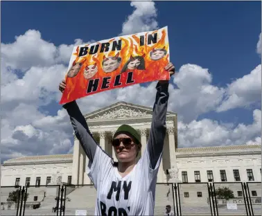  ?? THE ASSOCIATED PRESS ?? An abortion-rights protester displays a placard during a demonstrat­ion outside the Supreme Court in Washington, Saturday, June 25, 2022. The U.S. Supreme Court’s decision to end constituti­onal protection­s for abortion has cleared the way for states to impose bans and restrictio­ns on abortion — and will set off a series of legal battles.