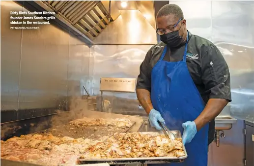  ?? PAT NABONG/SUN-TIMES ?? Dirty Birds Southern Kitchen founder James Sanders grills chicken in the restaurant.