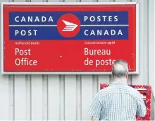  ?? DARREN CALABRESE/CP FILES ?? A man mails a letter outside a Canada Post office in Halifax earlier this year.