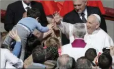  ?? AP PHOTO/GREGORIO BORGIA ?? Pope Francis salutes a child after leading the Easter Mass in St. Peter Square at the Vatican, Sunday, April 1, 2018.