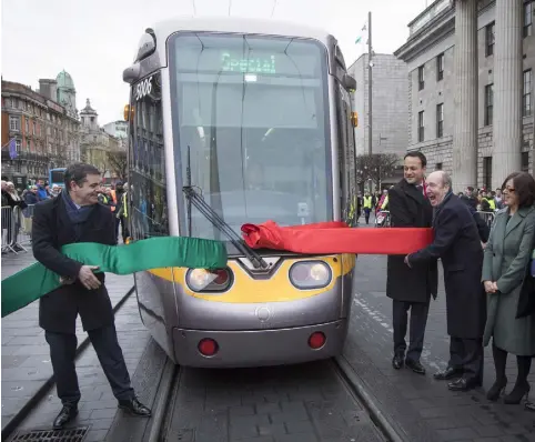  ??  ?? ALL TOGETHER NOW: It takes three Ministers of Transport, two former, one current, to launch the cross-city Luas yesterday