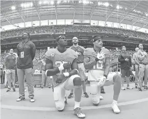  ?? JASEN VINLOVE, USA TODAY SPORTS ?? Joining the protests in the NFL about social injustice, the Dolphins’ Michael Thomas, left, and Kenny Stills kneel during the national anthem Nov. 6.