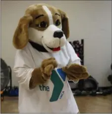  ?? MICHILEA PATTERSON — FOR DIGITAL FIRST MEDIA ?? Pottstown YMCA Aquatics Supervisor Aimee Gilbert dances during a family Zumba demonstrat­ion class while wearing the “Y-Doh the Y Dog” mascot uniform during the wellness center’s reopening.