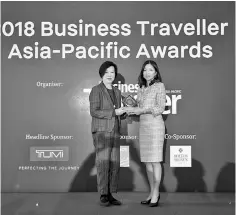  ??  ?? AirAsia Hong Kong and Macao chief executive officer Celia Lao (right) receives the trophy for Best Low-cost Airline at the 2018 Business Traveller Asia-Pacific Awards in Hong Kong.