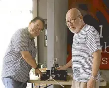  ??  ?? Two men and a baby press: The author Butch Dalisay with painter and printmaker Raul Isidro