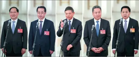  ?? KUANG LINHUA / CHINA DAILY ?? Five ministeria­l-level officials (from left) Jin Zhuanglong, Lu Zhiyuan, Huang Runqiu, Li Xiaopeng and Luo Wen answer questions after the plenary meeting of the National People’s Congress at the Great Hall of the People in Beijing on Friday.