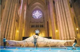  ?? MARY ALTAFFER AP ?? Volunteers raise a tent while building a field hospital Wednesday at the Cathedral of St. John the Divine in New York.