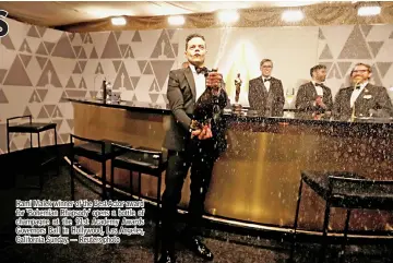  ?? — Reuters photo ?? Rami Malek winner of the Best Actor award for ‘Bohemian Rhapsody’ opens a bottle of champagne at the 91st Academy Awards Governors Ball in Hollywood, Los Angeles, California Sunday.