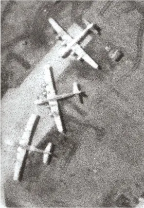  ??  ?? Above: Enlarged view of Russian Tu-4 “Bull” bombers (reverse-engineered B-29s) taken from a Haymaker flight. Below: Col. Griffin, wearing his original helmet, reacquaint­s himself with an old friend. (Photos courtesy of James P. Busha)