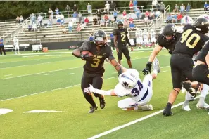  ?? Photo by Kevin Sutton ?? ■ Pleasant Grove’s Jayden Stewart (3) looks for running room while teammate Lance Jackson (40) blocks during Friday’s game at Hawk Stadium. The Hawks beat Midland Christian, 48-28.