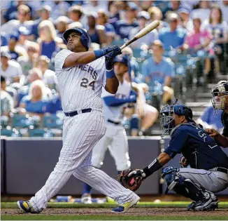  ?? DYLAN BUELL / GETTY IMAGES ?? Jesus Aguilar of the Brewers hits a home run in the eighth inning against the Braves at Miller Park. Milwaukee took three of four in the series.