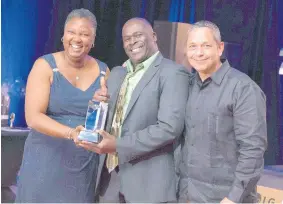  ??  ?? Wentworth Taylor (centre), Supervisor of the Year 2018, accepts his award from Betty Ann Brown, human resources director, and Omar Rivera, general manager of the Hyatt Ziva and Zilara Rose Hall.