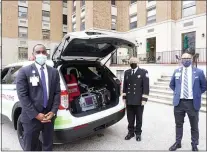  ?? SUBMITTED PHOTO ?? Chris Cullom, left, president of Mercy Catholic Medical Center; Larry Smythe, center, director of paramedics, Mercy Fitzgerald EMS; and James Green, right, vice president and chief developmen­t officer, Trinity Health Mid-Atlantic, attended the blessing and housing ceremony at the Mercy Fitzgerald Hospital earlier this month.