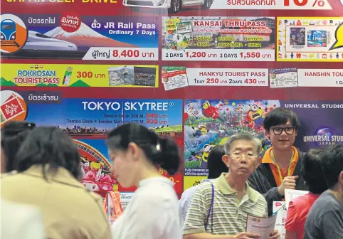  ?? SOMCHAI POOMLARD ?? People throng the Thai Internatio­nal Travel Fair 2018, held recently in Bangkok.