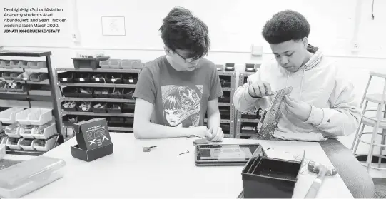  ?? JONATHON GRUENKE/STAFF ?? Denbigh High School Aviation Academy students Atari Abundo, left, and Sean Thicklen work in a lab in March 2020.