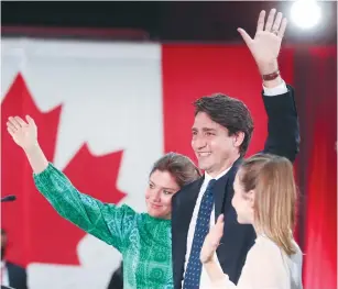  ?? CANADA’S PRIME MINISTER Justin Trudeau and his wife and daughter wave to supporters at an election night party in Montreal yeterday.
(Christinne Muschi/Reuters) ??