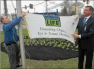  ?? PETE BANNAN – DIGITAL FIRST MEDIA ?? Chester County Hospital Security Manager John Mullin and hospital President and CEO Michael J. Duncan raise the Donate Life flag in honor of organ donors and recipients Tuesday kicking-off Donate Life month to promote the success of organ, eye, and...