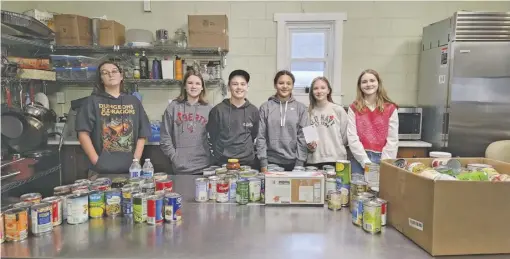  ?? BY MATT HUMMILL ?? Students Eugene Lopiano, Aubrey Murray, Jason Williams, Mariah Phillips, Emily Scheulen and Adlin Hubble delivered canned goods to the Rappahanno­ck Food Pantry last week.