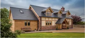  ??  ?? Above: This self build home by Welsh Oak Frame has characterf­ul cottage charm thanks to external exposed oak Above right: Full height glazing and a contempora­ry staircase give a modern edge to the inside of this Welsh Oak Frame project