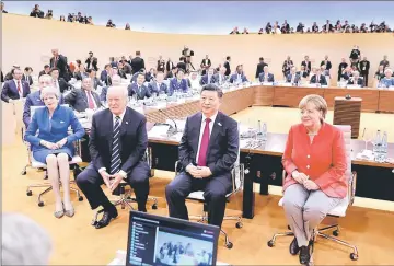  ??  ?? (Front, from left) May, Trump, Xi and Angela Merkel turn around for photograph­ers at the start of the first working session of the G20 summit. — Reuters photo