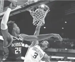  ??  ?? Suns forward Trevor Ariza (3) dunks against Kings guard Buddy Hield on Tuesday night at Talking Stick Resort Arena.