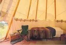  ?? Provided by Airbnb ?? The inside of the tipi features two twin beds and one queen bed topped with soft down comforters and wool blankets.