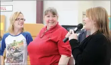  ??  ?? Rachel McAdams with Barnes & Noble in Fayettevil­le, right, announces Farmington High teacher Carol Bundsgaard as the store’s Favorite Teacher of the Year. Senior Kassandra Dankers, left, nominated Bundsgaard for the honor.