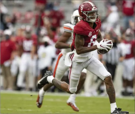  ?? MICKEY WELSH - THE ASSOCIATED PRESS ?? Alabamawid­e receiver Devonta Smith ( 6) runs with a reception for a touchdown against Auburn during an NCAA college football game in Tuscaloosa, Ala, in this Saturday, Nov. 28, 2020, file photo. The Southeaste­rn Conference championsh­ip game features two of the nation’s top playmakers, and neither is a quarterbac­k. Alabama receiver Devonta Smith and Florida tight end Kyle Pitts are the real stars of the league’s most potent offenses.