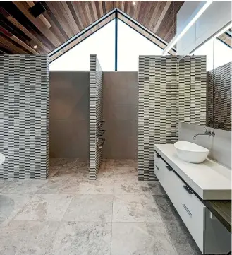 ??  ?? Sutton created this restful, calm bathroom in a modern architectu­rally designed home.