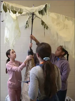  ?? (Arkansas Democrat-Gazette/Stephen Swofford) ?? Bryant Middle School teammates (clockwise from left) Riley McCarthy, Iman Elliott and Audrey Smart work to fix a prop before they perform Saturday during the Destinatio­n Imaginatio­n tournament at Don Roberts Elementary School in Little Rock. The tournament featured 80 teams and about 400 contestant­s, according to a news release.