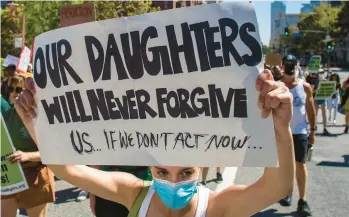  ?? APU GOMES/GETTY-AFP ?? A marcher holds a sign Sunday while taking part in an abortion-rights protest in downtown Los Angeles.