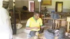  ??  ?? Alh. Abdullahi Shu'aibu (left) and another shoemaker at the Naraguta shoemaking hub, Jos