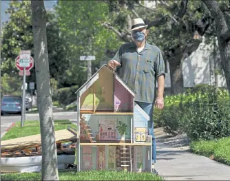  ?? AP PHOTO ?? Nathan Long, a video-game writer, poses for a picture with a dollhouse discarded on the curb for spring cleaning nearby his rental apartment in Glendale, Calif. He and his wife, Lili, have been unsuccessf­ul so far in their search for a home in Los Angeles.