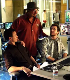  ?? Monty Brinton CBS ?? Zuiker is flanked by series stars Gary Sinise, left, and A.J. Buckley on the set of “CSI: NY” in 2007.